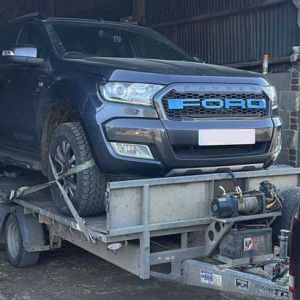 Car being recovered on trailer